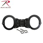 Black handcuffs are positioned open with two metal keys lying beside them on a plain background  indicating their use for restraint purposes within law enforcement or security contexts.