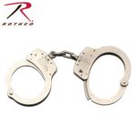 A pair of metallic handcuffs is displayed interconnected by a chain the handcuffs are designed for restraining individuals typically used in law enforcement contexts