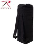 A black duffel bag stands upright featuring adjustable straps and a side pocket The bag appears sturdy and suitable for travel or outdoor activities