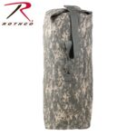 A cylindrical bag with a camouflage pattern stands upright showcasing a rolled top secured with a strap indicating suitability for outdoor or military use. The brand logo is visible.