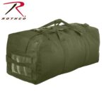A green nylon duffel bag sits upright with dual carrying handles and sturdy clips on top featuring a clear window for identification in a plain background.