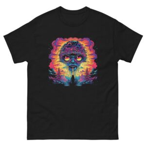 A colorful graphic of an alien face with large eyes and dripping mouth dominates a black shirt design  set against a vibrant sunset with trees and clouds in the background.