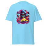 A light blue t-shirt features a vibrant graphic of a skull wearing sunglasses and a helmet surrounded by swirling colors and flames with a faint landscape in the background.