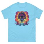 A blue t-shirt displays a vibrant graphic of a fantastical face with large eyes and colorful swirling patterns emanating from it set against a sunset with trees and abstract elements.