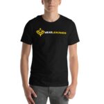 A person stands wearing a black t-shirt featuring a lemon logo and the text WE ARE LEMONADE in yellow and white on the front in a neutral setting.