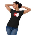 A woman is smiling and stretching her arms behind her head while wearing a black t-shirt featuring a playful design with red and white characters along with the text FOREVER MINE.