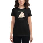 A woman wears a black t-shirt featuring a cartoon design of an arm holding a wine bottle with the text Happy St. Patrick Wine because adulting is hard below it.