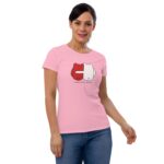 A woman is standing and smiling while wearing a fitted pink t-shirt featuring a graphic of two characters in red and white with the text FOREVER MINE below them.