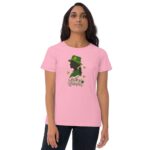 A person wearing a pink t-shirt stands confidently with their arms at their sides displaying a green silhouette of a woman with a hat surrounded by shamrock leaves and the text "Lucky Woman"