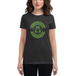 A woman is wearing a dark gray t-shirt displaying a green circular design featuring a leprechaun with text that reads St. Patrick's Day Luck of the Irish in a festive context.