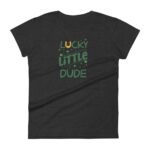 A black t-shirt displays the text “LUCKY LITTLE DUDE” in playful green letters with a horseshoe graphic above and decorative sparkles around the words suggesting a fun and casual theme.