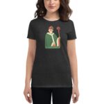 A woman wears a dark t-shirt featuring an illustration of Saint Patrick holding a staff with a cross. The design includes the text "20 - SAINT PATRICK - 24" below the figure.