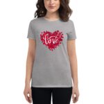 A gray t-shirt features a heart shape made of red rose petals with the word love elegantly scripted in the center. A young woman stands wearing the shirt  smiling.