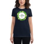 A person is wearing a dark T-shirt featuring a circular graphic with a green leafy design and the text "Happy st. patrick's day" in the center  celebrating the holiday.