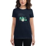 A woman wearing a dark shirt displays a design featuring clover leaves and a quote about good luck and happiness with the text Happy St. Patrick's Day below the design