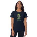 A woman stands wearing a dark t-shirt featuring a green silhouette of a girl in a hat surrounded by clovers with the text lucky woman beneath it in a festive context.