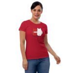 A woman stands wearing a red t-shirt featuring a cartoon design of two characters  one red and one white  close together with the text "FOREVER MINE" below  set against a plain white background.