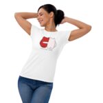 A woman smiles while stretching her arms behind her head  wearing a white t-shirt featuring a design of two cartoon characters with the text "FOREVER MINE" prominently displayed.
