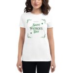 A woman stands wearing a white t-shirt displaying the text "HAPPY SAINT PATRICK'S DAY" in green with decorative elements  celebrating the festive occasion of Saint Patrick's Day.