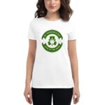 A woman wears a white t-shirt featuring a green logo that reads ST. PATRICK'S DAY LUCK OF THE IRISH with a design of a leprechaun's face in the center.