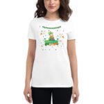 A white t-shirt features a colorful graphic of a leprechaun celebrating St. Patrick's Day surrounded by festive elements like shamrocks and stars in a cheerful context. Text reads "ST. PATRICK'S DAY."