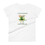 A white t-shirt displays three women in festive green outfits celebrating with raised arms surrounded by shamrocks text reads IT'S THE DAY OF GOOD FORTUNE HAPPY ST. PATRICK'S DAY