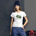 A woman wears a white t-shirt with a green design and text that says I LOVE MY GREENS HAPPY ST. PATRICK in a cluttered urban environment with a dark background and red chains visible.