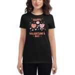 A person wears a black t-shirt featuring cartoon hearts celebrating Valentine's Day with text stating "HAPPY VALENTINE'S DAY" surrounded by colorful stars and hearts in a cheerful design.