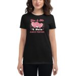 A woman wears a black t-shirt featuring two cartoon hearts holding hands. The text reads "You & Me ALWAYS TOGETHER" above the image on a checkered background.