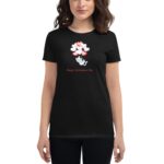 A woman is wearing a black t-shirt featuring a cartoon cat amidst red and white heart shapes with the text Happy Valentine's Day below the design in a casual setting.