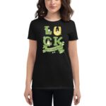 A woman wears a black t-shirt displaying the text "LUCK ST. PATRICK'S DAY" with green illustrations  including shamrocks  a horseshoe  and other festive designs  celebrating St. Patrick's Day.