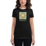 A woman wears a black t-shirt featuring a colorful graphic with a shamrock and the text HAPPY ST PATRICK'S DAY against a neutral background  celebrating the holiday.