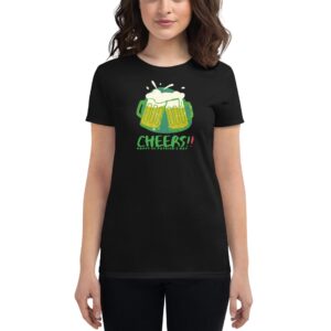 A woman stands wearing a black t-shirt featuring two beer mugs clinking together with foam spilling out surrounded by the text CHEERS!! HAPPY ST.PATRICK'S DAY in festive colors.