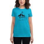 A turquoise t-shirt features a black graphic of two birds on a branch with hearts above them and the text “Spring in the air” below  worn by a young woman.
