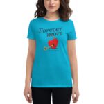 A woman wearing a bright turquoise t-shirt stands confidently the shirt features a graphic of a red heart lock with a key above the words Forever more and the text you won my heart below