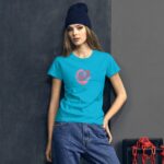 A young woman stands confidently against a dark wall wearing a bright blue t-shirt with a rose graphic and the word love  complemented by relaxed blue jeans and a dark beanie.