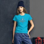 A woman is posing while wearing a bright blue T-shirt featuring the text "my Valentine's Day" in a playful design  set against a dark textured background with chains and a box.