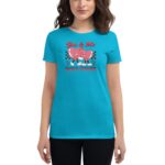 A woman wearing a bright turquoise t-shirt with a playful graphic of two smiling hearts holding hands is standing against a plain background. The text reads "You & Me ALWAYS TOGETHER".