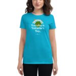 A woman wears a bright turquoise t-shirt displaying the text "Everyday is Valentine's Day" with floral designs and a butterfly against a neutral background.