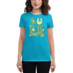 A woman wears a vibrant turquoise t-shirt featuring the word "LUCK" in decorative letters surrounded by shamrocks and a banner that reads "ST. PATRICK'S DAY" in a festive context.