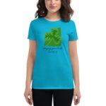 A woman wearing a vibrant turquoise t-shirt features a green shamrock graphic with text that reads Enjoying your luck It's Saint Patrick's Day against a neutral background.