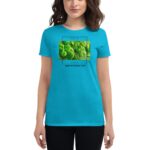 A person wears a bright turquoise t-shirt featuring a graphic of green clovers with the text "FEELIN' LUCKY HAPPY ST. PATRICK'S DAY" in a casual setting.
