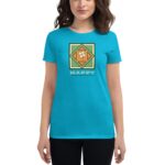A woman wearing a bright blue t-shirt stands confidently featuring a graphic design with a clover and the text HAPPY ST PATRICK'S DAY against a vibrant background.