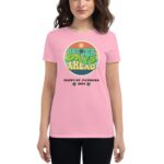 A woman wears a pink t-shirt featuring a colorful graphic that states “BETTER DAYS AHEAD” along with the text “HAPPY ST. PATRICKS 2024” and decorative shamrocks.