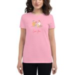 A person wearing a pink shirt with an illustration of two individuals playfully interacting. The text "Love You" is displayed below the illustration  suggesting a romantic or affectionate theme.