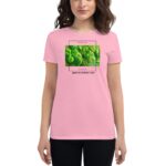 A woman wears a pink t-shirt featuring a green shamrock graphic and text that reads FEELIN' LUCKY HAPPY ST.PATRICK'S DAY in a celebratory context for St. Patrick's Day.