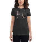 A dark grey t-shirt features decorative graphics including pink circles and stars with the text love always. A woman stands wearing the shirt  displaying its design.