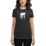 A woman wears a dark gray t-shirt featuring a cute illustration of two cartoon characters standing together  surrounded by colorful hearts  with the name "Caitlyn" subtly included below.