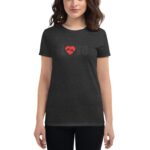 A woman wearing a dark t-shirt stands with arms at her sides. The shirt features a red heart design with the word "Love" in a lighter color printed above it.