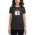 A person wearing a dark shirt displays a graphic of two cartoon cats  one adorned with a floral crown  surrounded by hearts with the text Happy Valentine's Day below them.